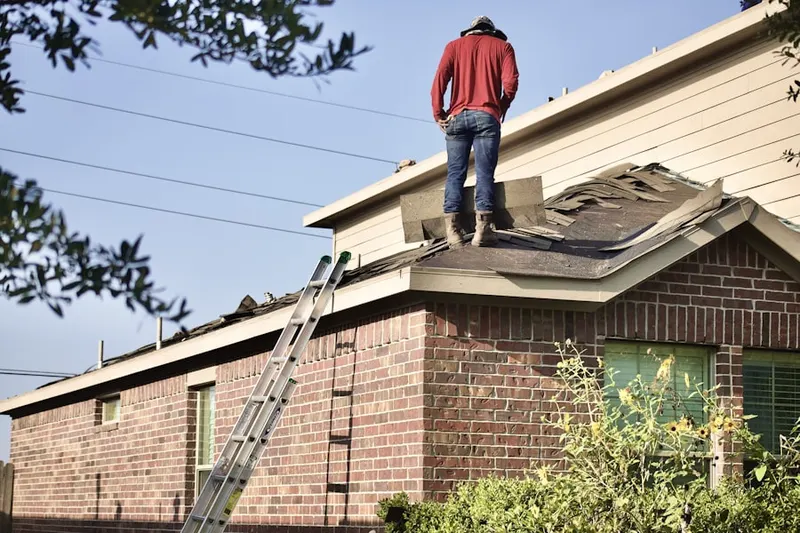 Professional roofer working on a residential roof in Bramblewood